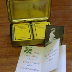 Princess Mary Christmas Gift Content, tobacco and cigarettes in yellow packing, a Christmas card and a photograph of Princess Mary.