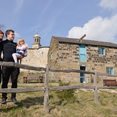 A family stand outside Raindale Mill at York Castle Museum (Image Mike Cowling)